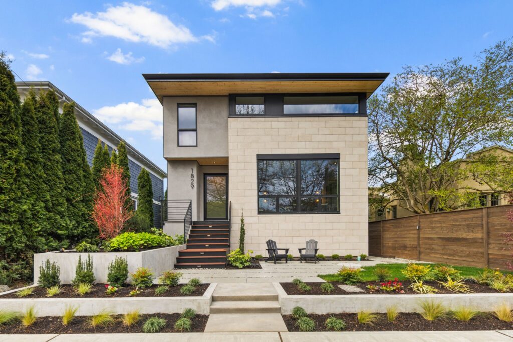 MPC Exterior - New construction home in Seattle with stucco, limestone, and large windows with hardscape installation
